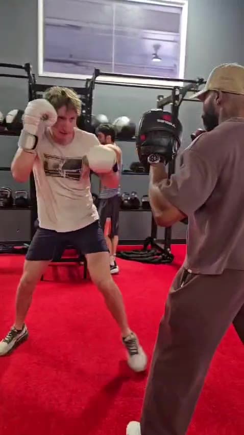 A client in gloves squaring up to Daine Chang's pads