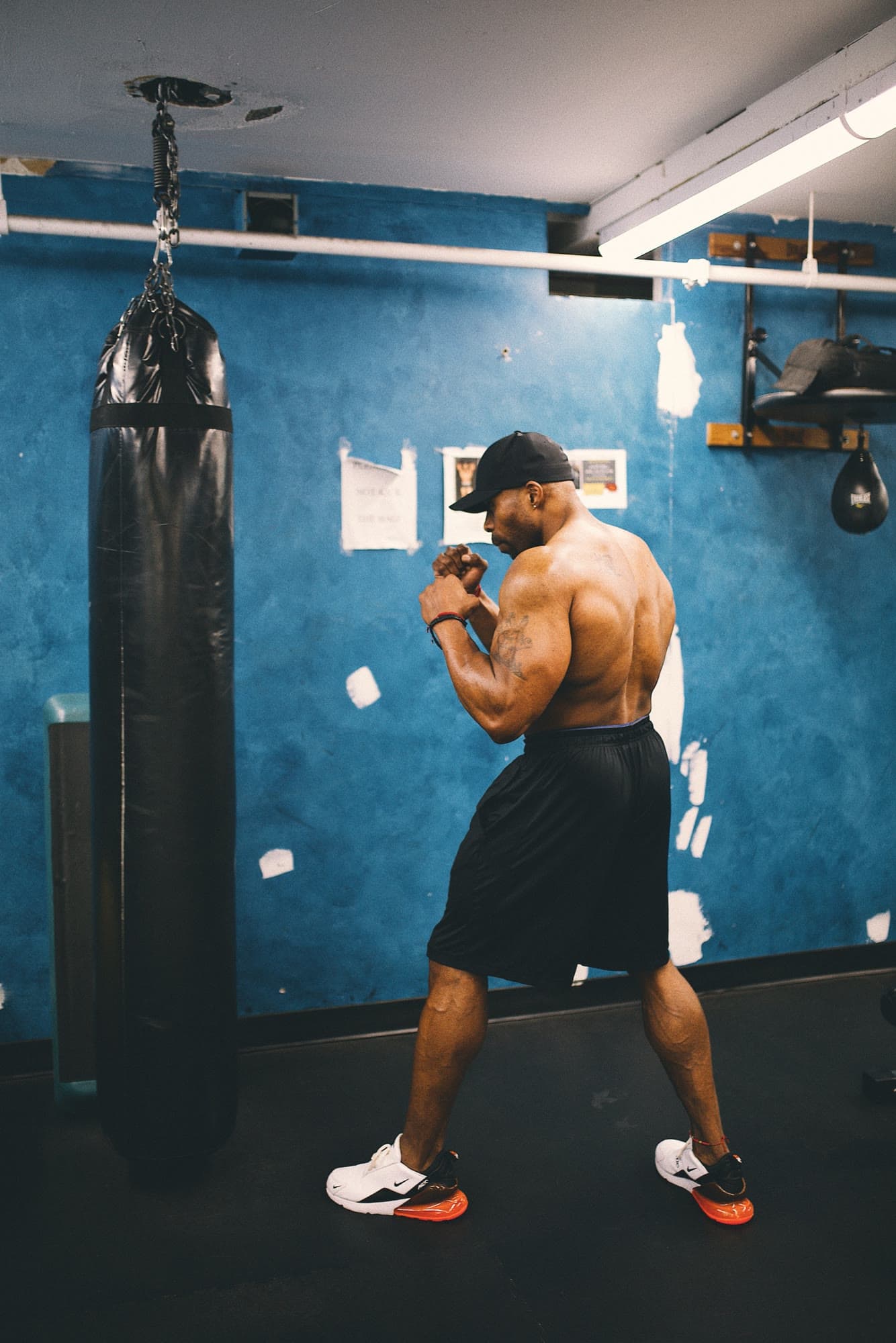 Daine Chang shadowboxing beside a heavy bag